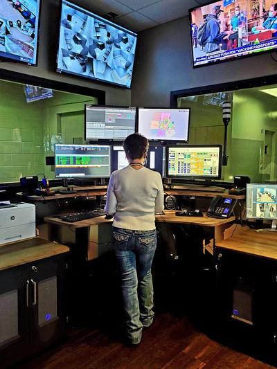 9-1-1 Dispatcher Standing at a Console